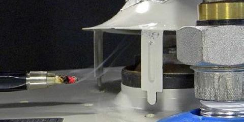 A picture of a smoke pen being used to test the vent intake of a combustion appliance.  The smoke is being pulled into the vent.
